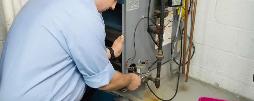 Furnace repair technician inspecting and servicing a home heating system in Arlington, TX