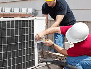 HVAC technicians repairing an outdoor AC unit on a rooftop in Arlington, TX